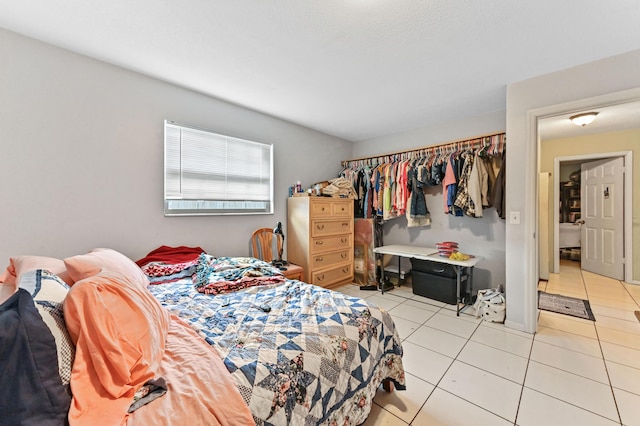 tiled bedroom featuring a closet