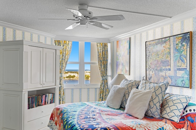 bedroom with ceiling fan, ornamental molding, and a textured ceiling