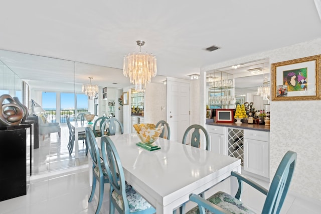 dining room featuring a notable chandelier and light tile patterned floors