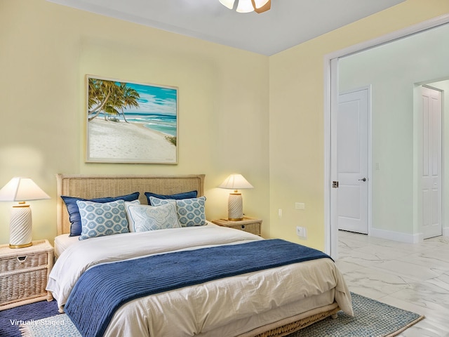 bedroom with a ceiling fan, baseboards, and marble finish floor