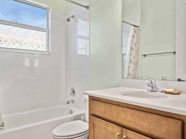 bathroom with shower / bath combo with shower curtain, toilet, and vanity