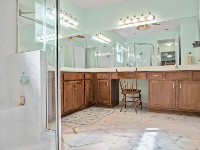 bathroom with vanity, a ceiling fan, a stall shower, and marble finish floor