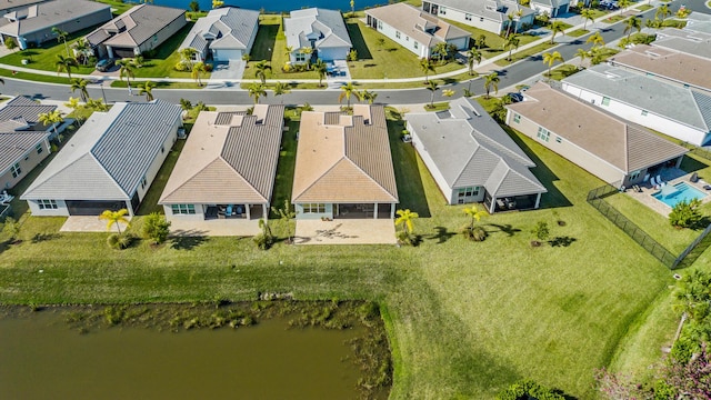 birds eye view of property with a residential view and a water view