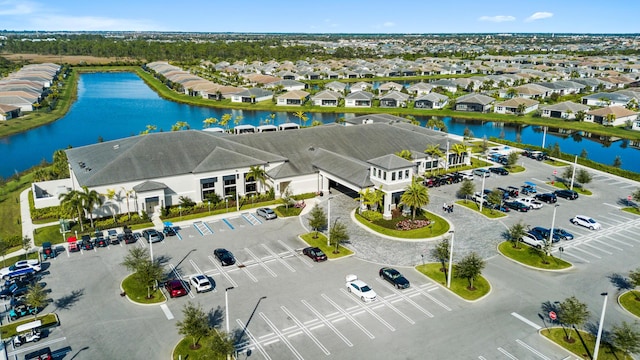 drone / aerial view featuring a residential view and a water view