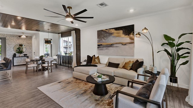 living room featuring wood ceiling, crown molding, ceiling fan, and hardwood / wood-style flooring