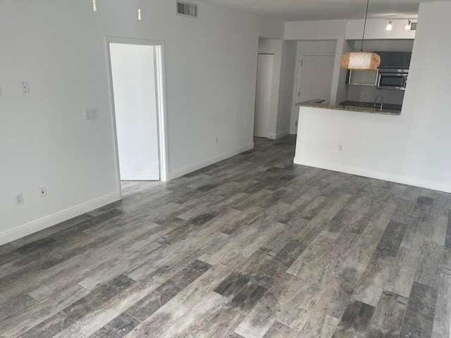 unfurnished living room with dark hardwood / wood-style flooring