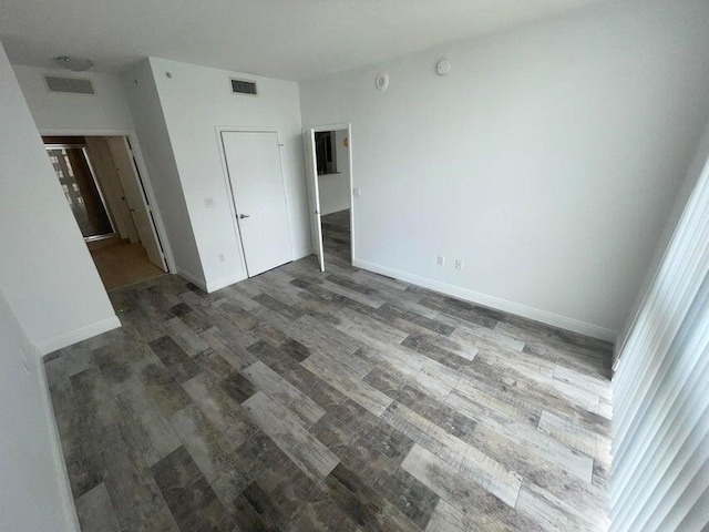 unfurnished bedroom featuring dark hardwood / wood-style floors