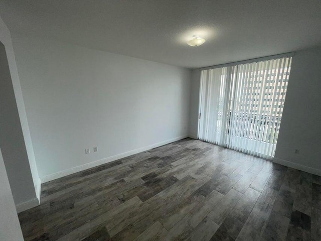 spare room with dark hardwood / wood-style flooring