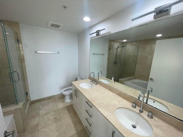 full bathroom featuring vanity, toilet, and separate shower and tub