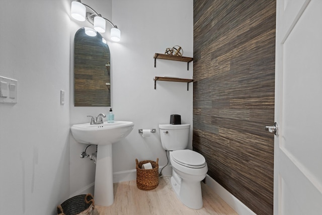 half bath with toilet and baseboards