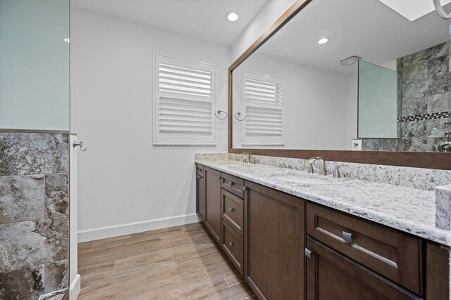 full bathroom with a walk in shower and wood finished floors