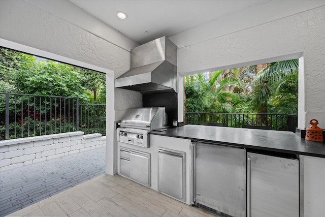 view of patio featuring exterior kitchen, a grill, and fence