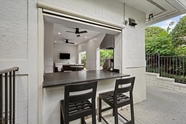 view of patio / terrace with outdoor dry bar and a ceiling fan