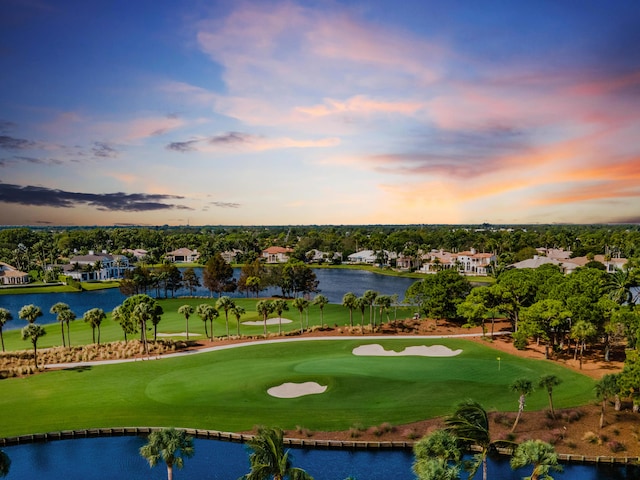 view of home's community with view of golf course, a water view, and a residential view