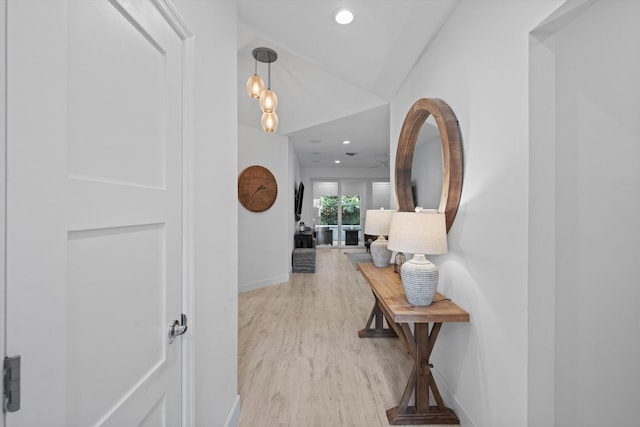 hallway featuring light wood finished floors, recessed lighting, and baseboards