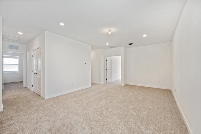 empty room with recessed lighting, visible vents, light colored carpet, and attic access