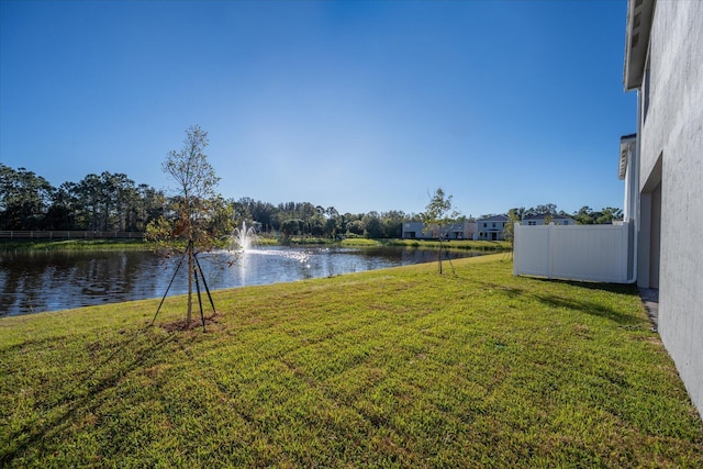 view of yard with fence and a water view