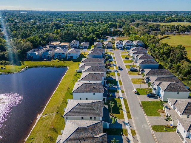 drone / aerial view featuring a residential view and a water view