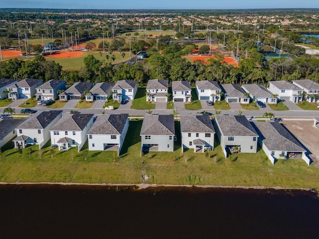 drone / aerial view with a residential view and a water view