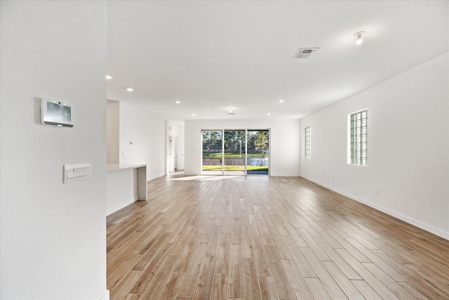 unfurnished living room featuring recessed lighting, visible vents, baseboards, and light wood-style floors