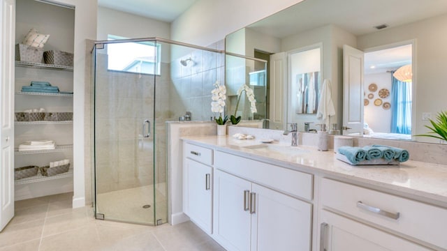 full bathroom featuring tile patterned flooring, a shower stall, and vanity