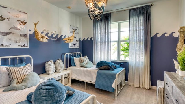 bedroom featuring a chandelier, baseboards, and carpet floors