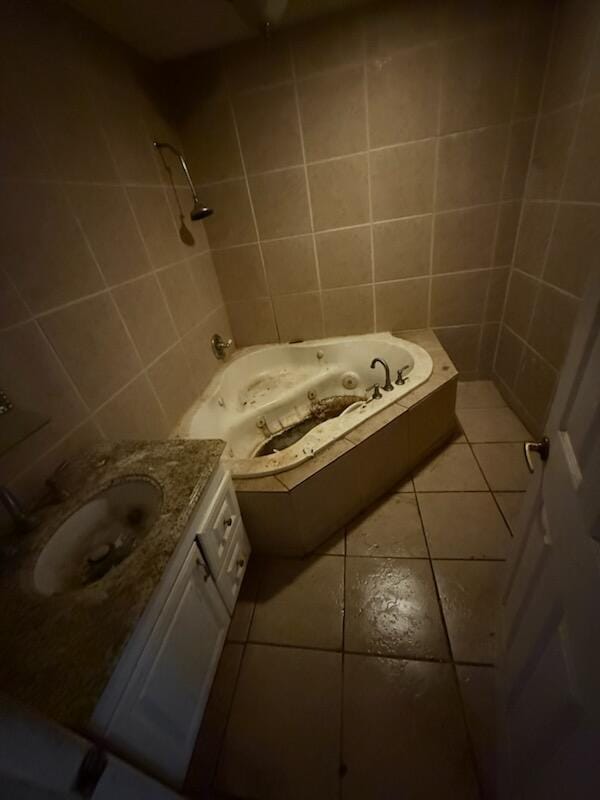 bathroom featuring a whirlpool tub, vanity, and tile patterned floors