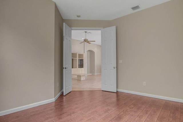 6731 Southport Dr W, Boynton Beach, FL 33472 - unfurnished room with wood finished floors, arched walkways, baseboards, and visible vents