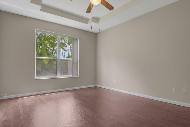 6731 Southport Dr W, Boynton Beach, FL 33472 - spare room with a ceiling fan, a tray ceiling, baseboards, and wood finished floors