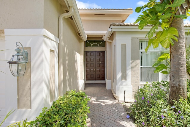 6731 Southport Dr W, Boynton Beach, FL 33472 - property entrance featuring stucco siding and a tiled roof