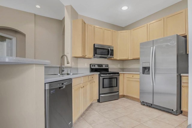 6731 Southport Dr W, Boynton Beach, FL 33472 - kitchen featuring light countertops, a sink, light brown cabinetry, and appliances with stainless steel finishes