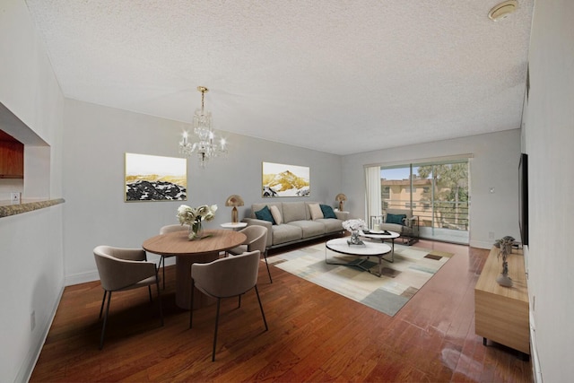 dining room featuring a notable chandelier, dark hardwood / wood-style floors, and a textured ceiling