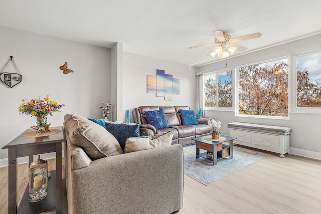 living room featuring ceiling fan and light hardwood / wood-style floors