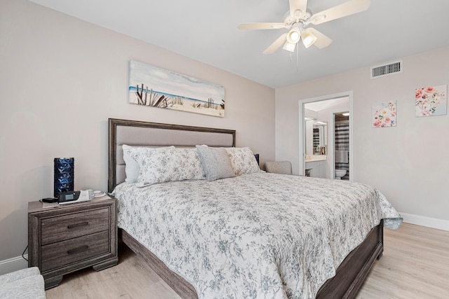 bedroom with connected bathroom, ceiling fan, and light wood-type flooring