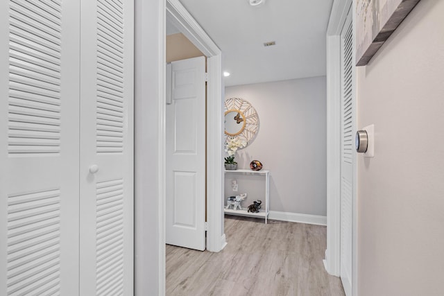 hallway with light hardwood / wood-style flooring