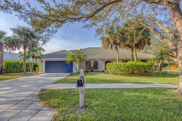 view of front of house with a garage and a front lawn