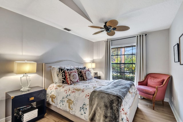 bedroom featuring hardwood / wood-style floors and ceiling fan