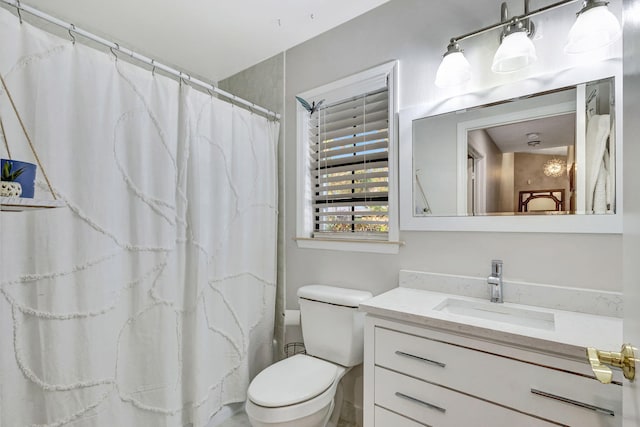 bathroom with vanity, curtained shower, and toilet