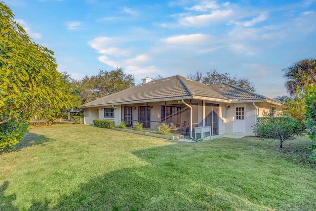 rear view of house with a lawn