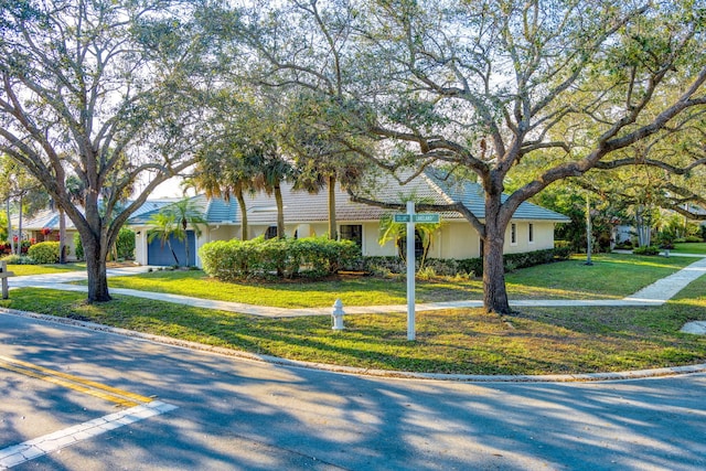 view of front of house with a garage and a front yard