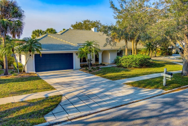 view of front of property featuring a garage and a front lawn