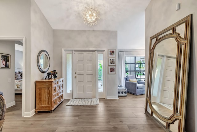 entrance foyer with hardwood / wood-style flooring and a notable chandelier