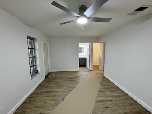 unfurnished room with ceiling fan and hardwood / wood-style floors