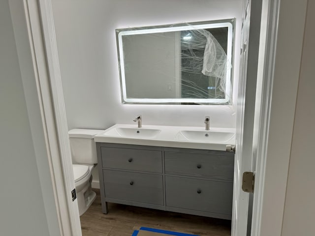 bathroom featuring vanity and toilet