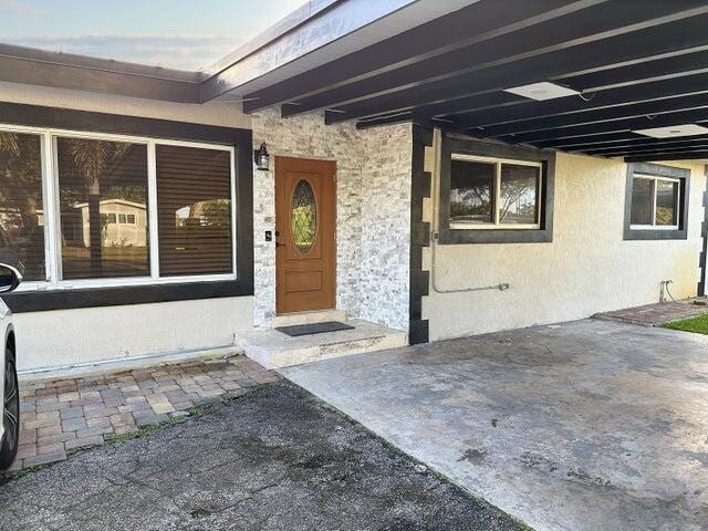 property entrance featuring a patio area