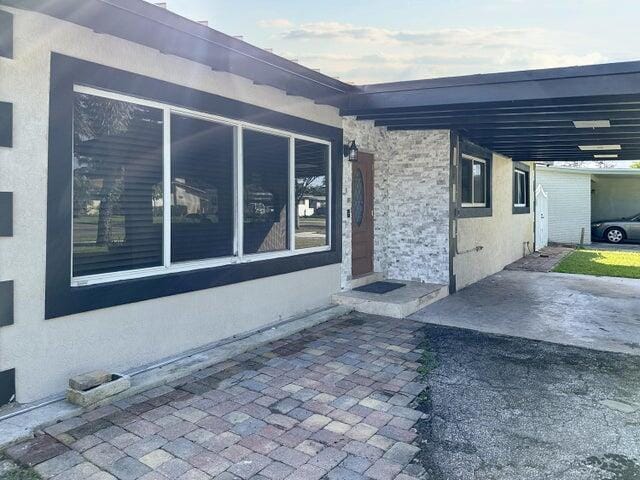 view of side of property featuring a carport