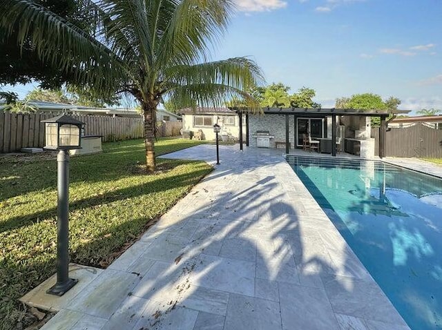 view of swimming pool with a lawn and a patio