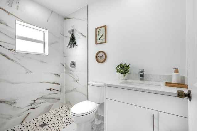 bathroom with a marble finish shower, toilet, vanity, and marble finish floor