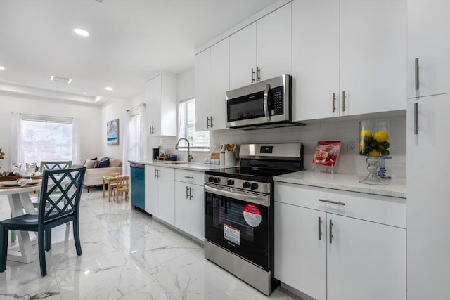 412 NW 13th Ave, Boynton Beach, FL 33435 - kitchen with a sink, decorative backsplash, stainless steel appliances, white cabinets, and marble finish floor