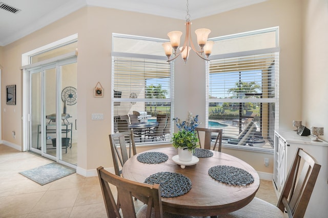 tiled dining room with an inviting chandelier and crown molding